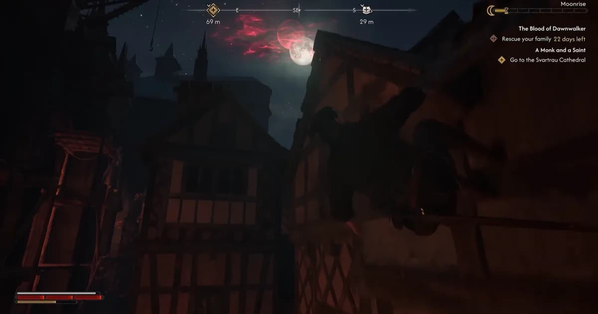 A cloaked figure moves across medieval rooftops beneath a crimson moon during the night.