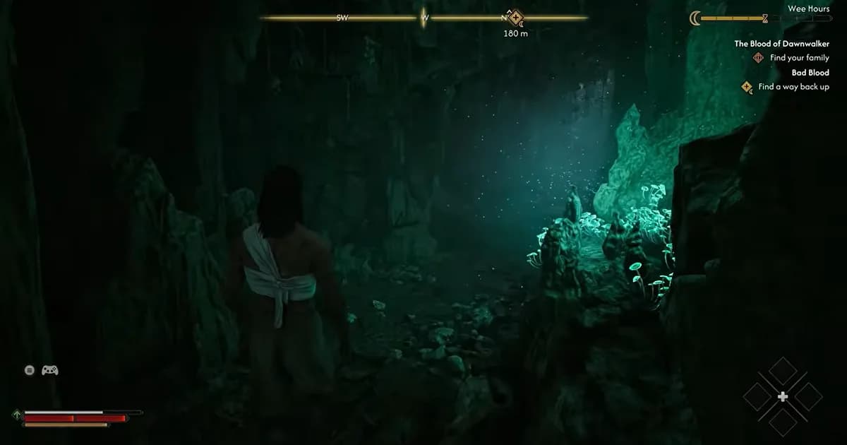 A lone traveller explores a dark cave illuminated by glowing green crystals and fungi.