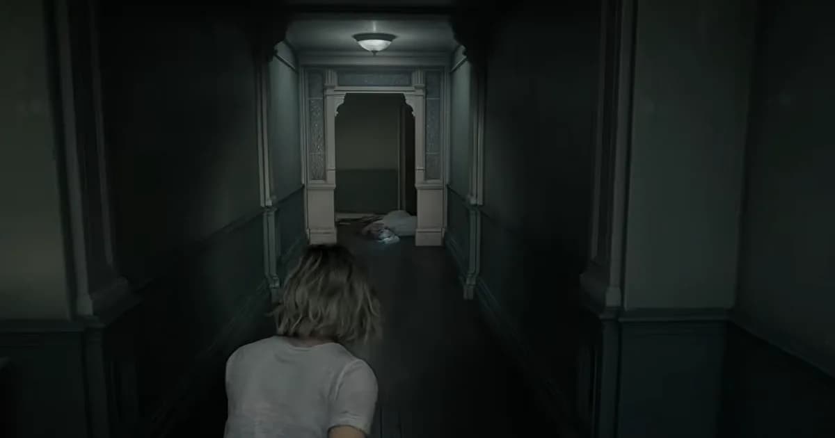 Grace seen from over the shoulder, moving down a dim, blue-toned corridor toward a doorway where a pale light picks out a shape slumped on the floor.
