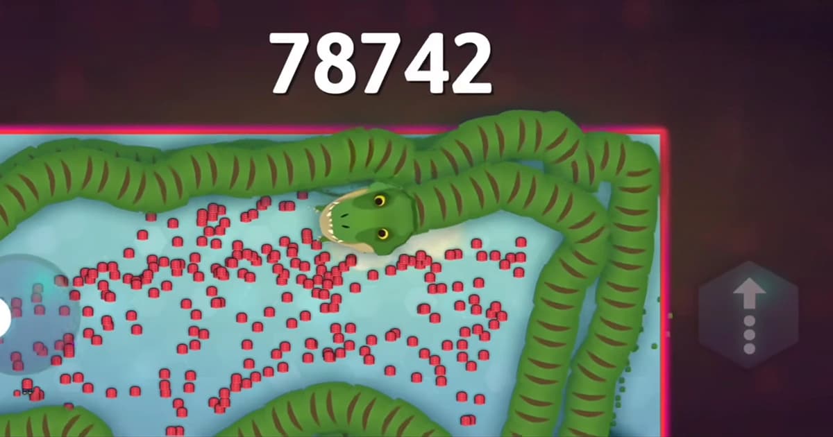 A giant green snake coils around a huge pile of glowing food while chasing a five-figure score in Snake.io.